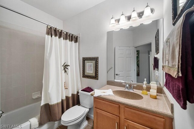 full bathroom with vanity, toilet, and shower / bath combo with shower curtain