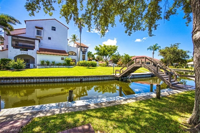 dock area featuring a lawn and a water view