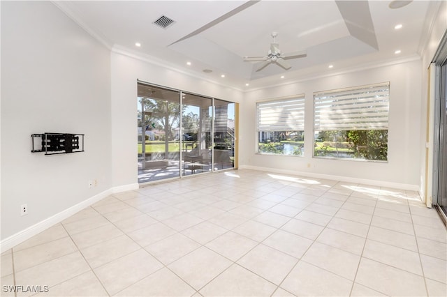 unfurnished room with light tile patterned floors, ornamental molding, a raised ceiling, and ceiling fan