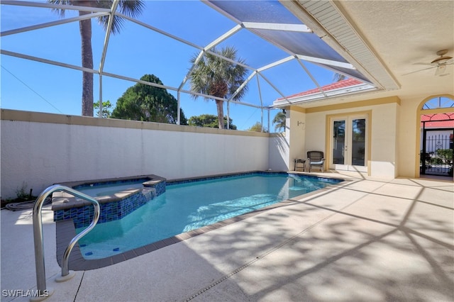 view of pool featuring french doors, a lanai, an in ground hot tub, ceiling fan, and a patio