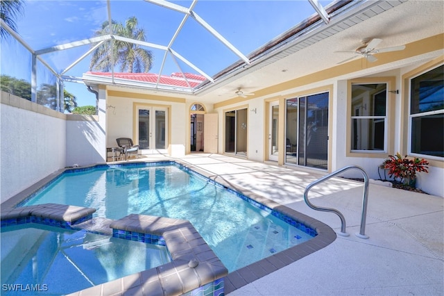 view of swimming pool featuring french doors, ceiling fan, glass enclosure, and a patio area