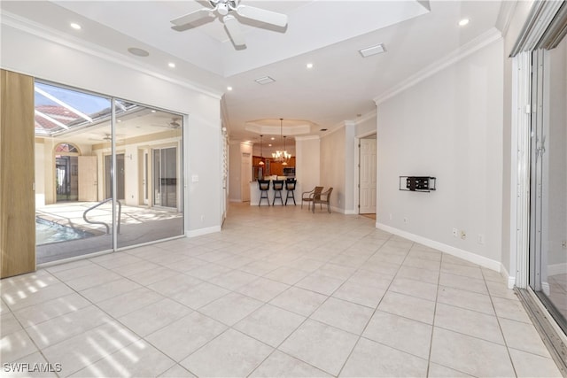 tiled spare room with crown molding, a tray ceiling, and ceiling fan with notable chandelier