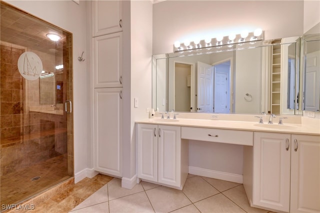 bathroom featuring walk in shower, vanity, and tile patterned flooring