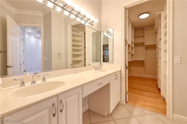 bathroom with vanity, crown molding, and tile patterned floors