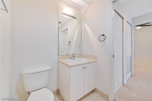 bathroom featuring tile patterned floors, toilet, vanity, and ceiling fan