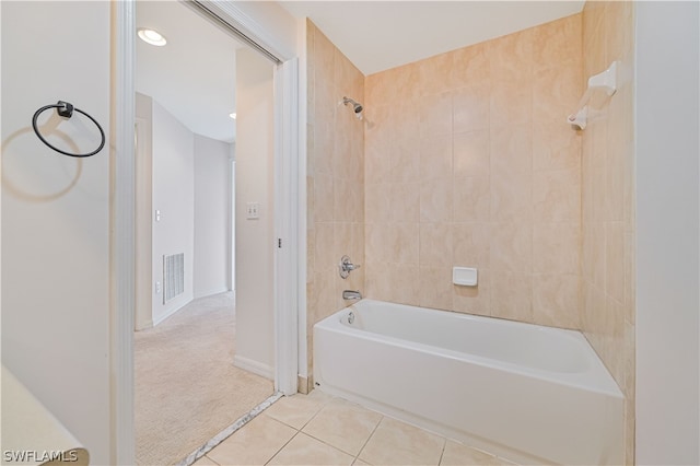 bathroom featuring tiled shower / bath and tile patterned flooring