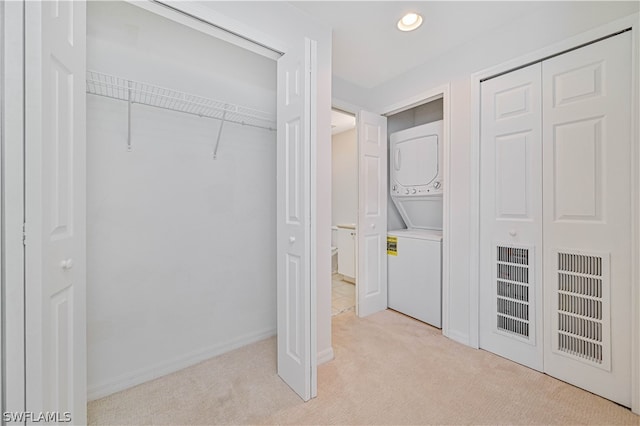 closet with stacked washer and dryer