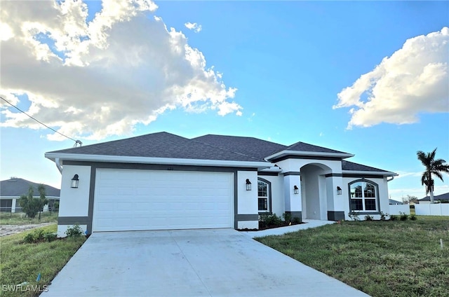 view of front facade featuring a garage and a front lawn