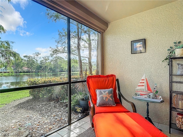 sunroom / solarium featuring a water view