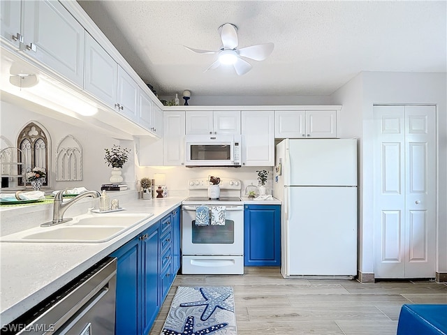 kitchen featuring sink, blue cabinets, white appliances, white cabinets, and light wood-type flooring