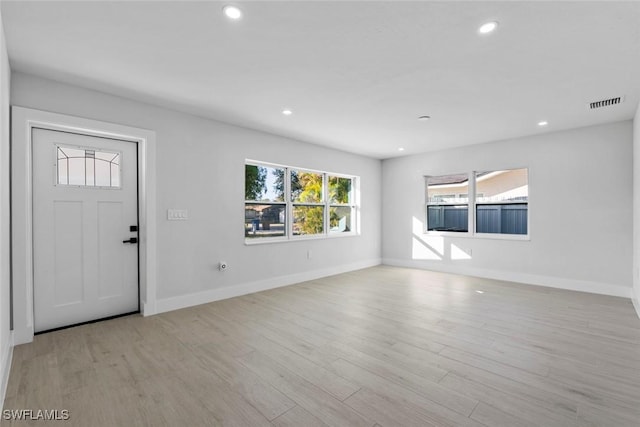 entrance foyer featuring light hardwood / wood-style flooring and a healthy amount of sunlight