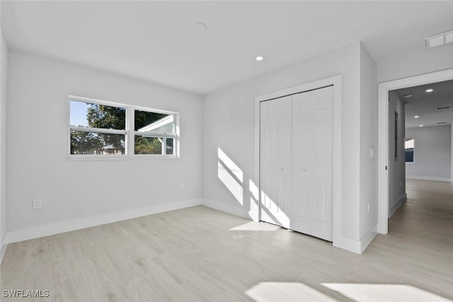 empty room with light hardwood / wood-style floors