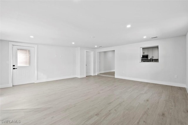 interior space with light wood-type flooring and sink