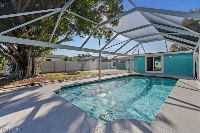 view of pool featuring glass enclosure and a patio area