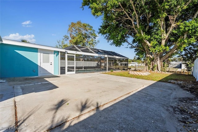 view of patio / terrace featuring a lanai and a swimming pool