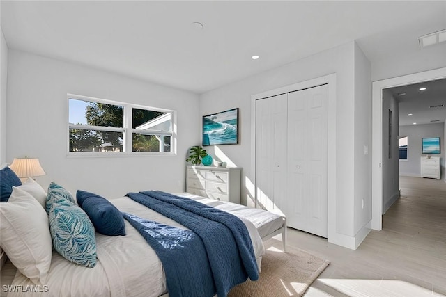 bedroom featuring light hardwood / wood-style flooring and a closet