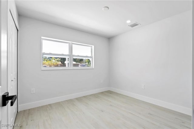 empty room with light hardwood / wood-style floors