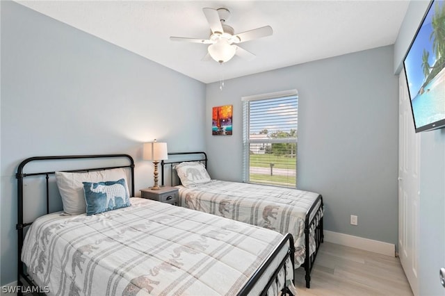 bedroom with ceiling fan and light hardwood / wood-style floors