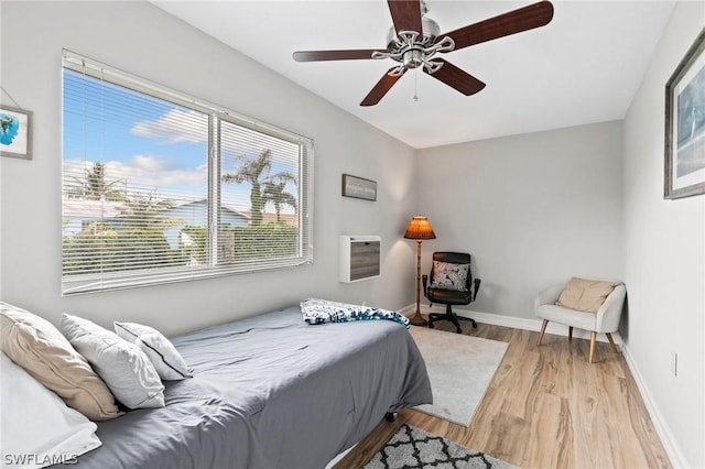 bedroom with ceiling fan and light wood-type flooring