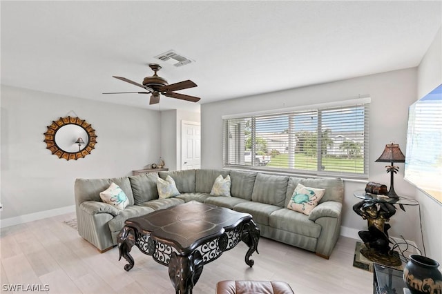 living room with light hardwood / wood-style floors and ceiling fan