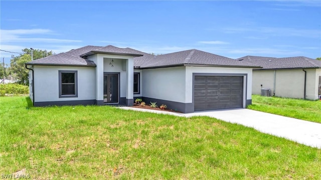 view of front facade featuring central AC unit, a garage, and a front lawn