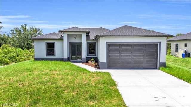 view of front of property with a garage and a front yard