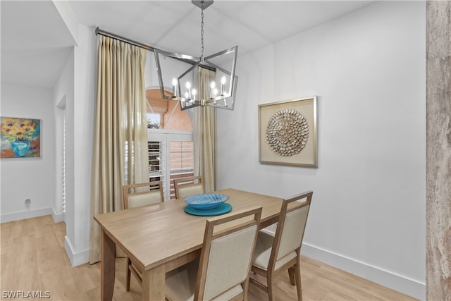 dining room featuring light hardwood / wood-style floors and a chandelier