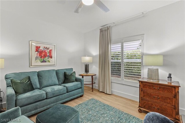 living room featuring light hardwood / wood-style flooring and ceiling fan