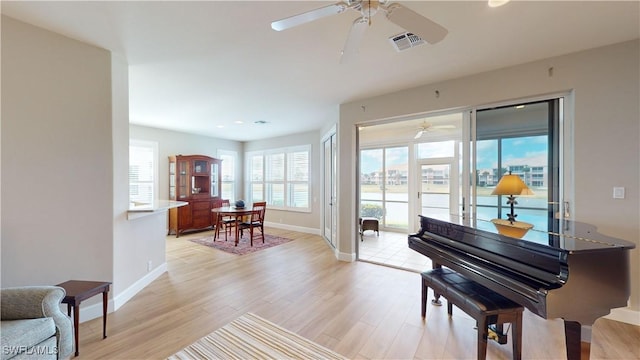 miscellaneous room with ceiling fan and light hardwood / wood-style flooring