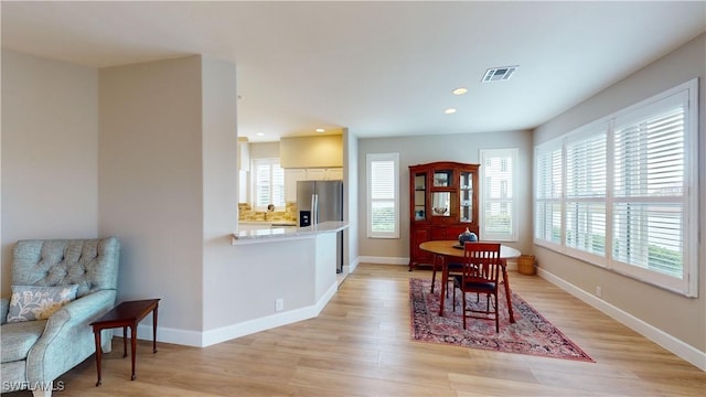 dining space featuring light wood-type flooring