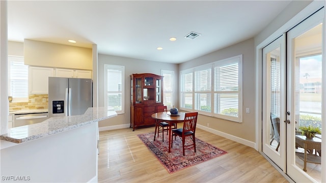 dining space with light hardwood / wood-style flooring