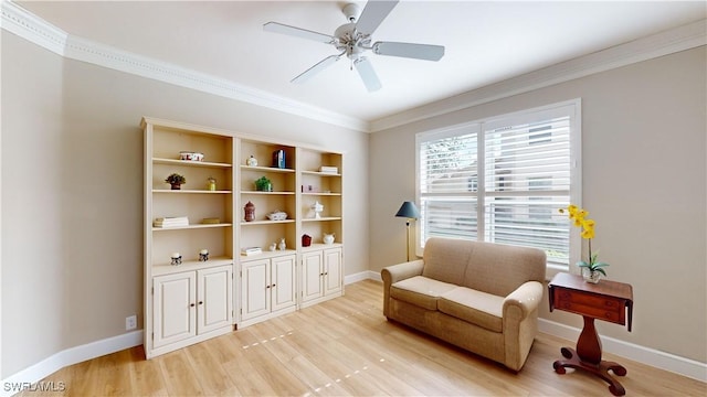 living area with ceiling fan, crown molding, and light hardwood / wood-style flooring