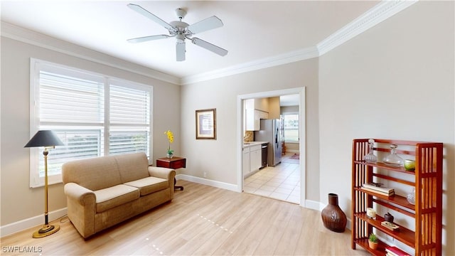 sitting room with light hardwood / wood-style floors, ceiling fan, and ornamental molding