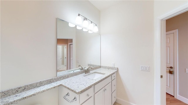 bathroom featuring wood-type flooring and vanity