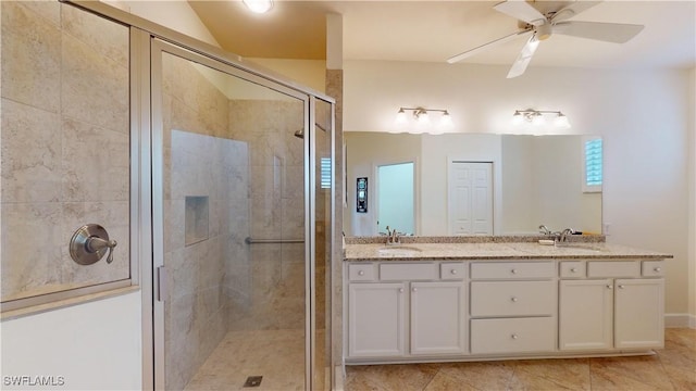 bathroom with tile patterned flooring, ceiling fan, a shower with door, and vanity