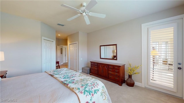 carpeted bedroom with ceiling fan and multiple windows