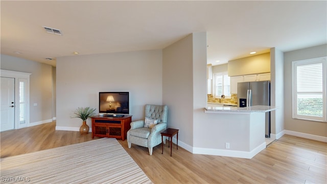 sitting room with light hardwood / wood-style floors