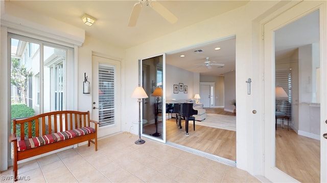 sunroom featuring ceiling fan