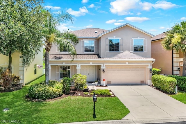 view of front of house featuring a garage and a front lawn