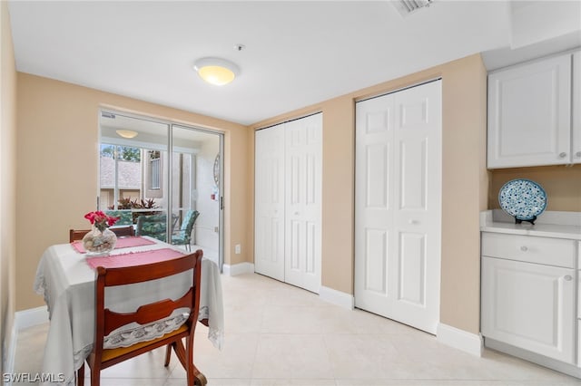 dining area featuring light tile patterned flooring