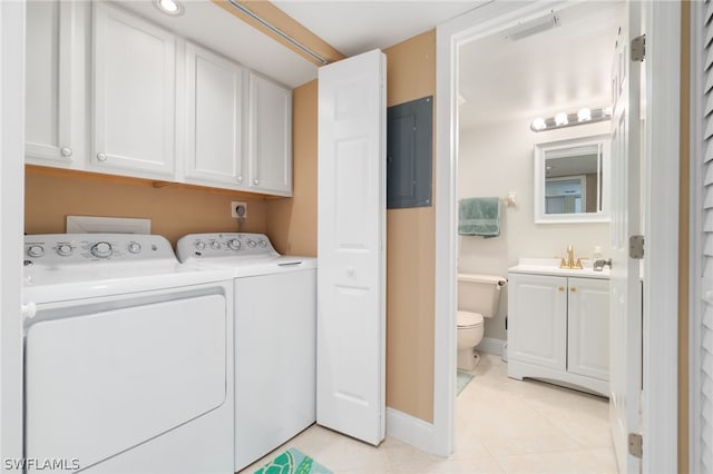 laundry area featuring light tile patterned floors, baseboards, cabinet space, electric panel, and washing machine and clothes dryer