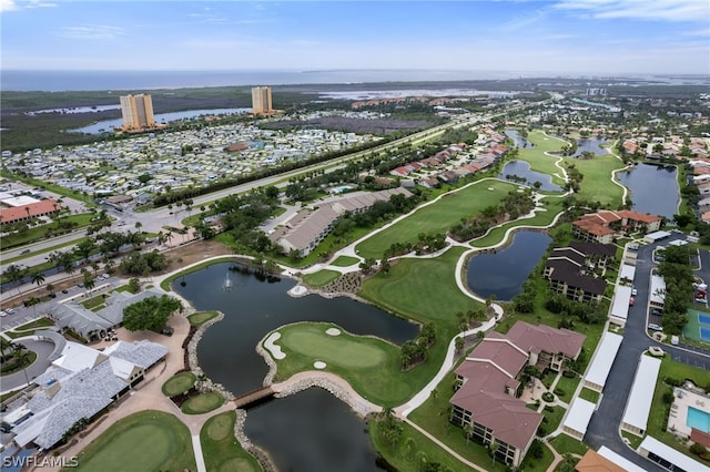 birds eye view of property featuring view of golf course, a water view, and a residential view