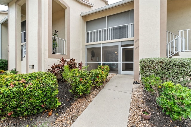 entrance to property with stucco siding