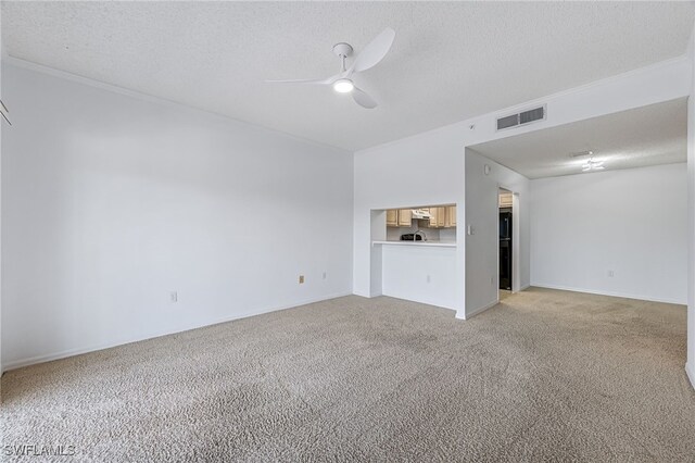 unfurnished living room featuring light carpet, visible vents, a textured ceiling, and a ceiling fan