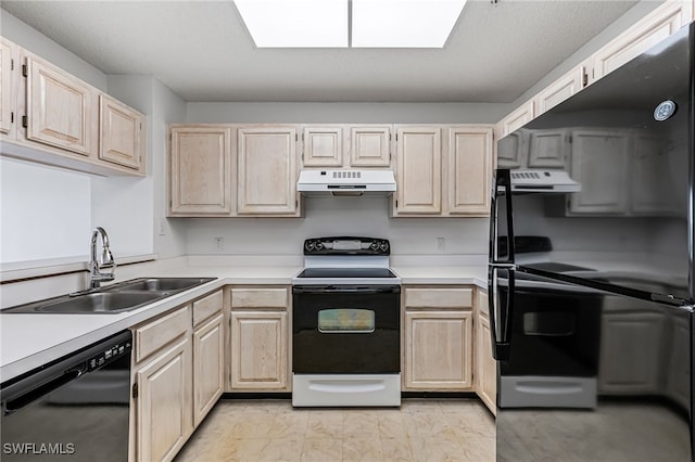 kitchen featuring black appliances, under cabinet range hood, light countertops, and a sink