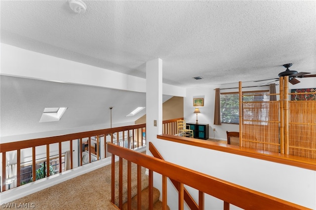 hallway with carpet flooring and lofted ceiling