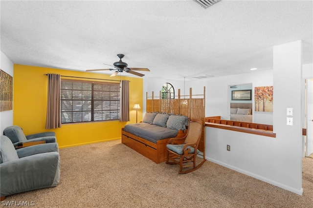 living room featuring ceiling fan, a textured ceiling, and carpet flooring