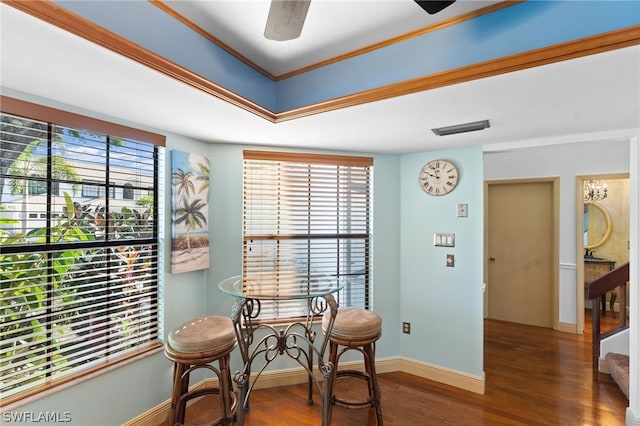 dining area featuring ceiling fan, crown molding, and dark wood-type flooring