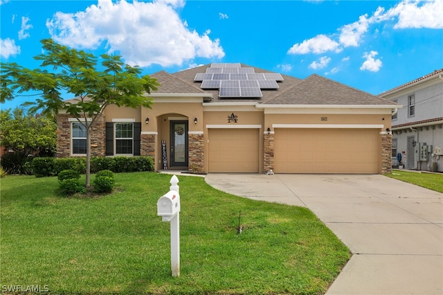 view of front of property with solar panels, a garage, and a front yard