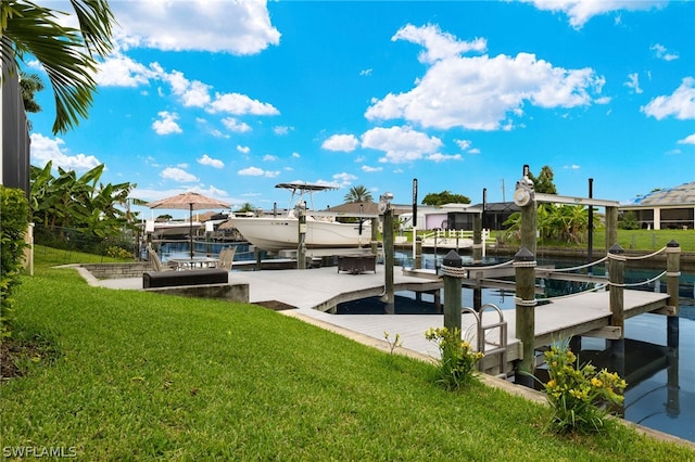 dock area with a water view and a yard